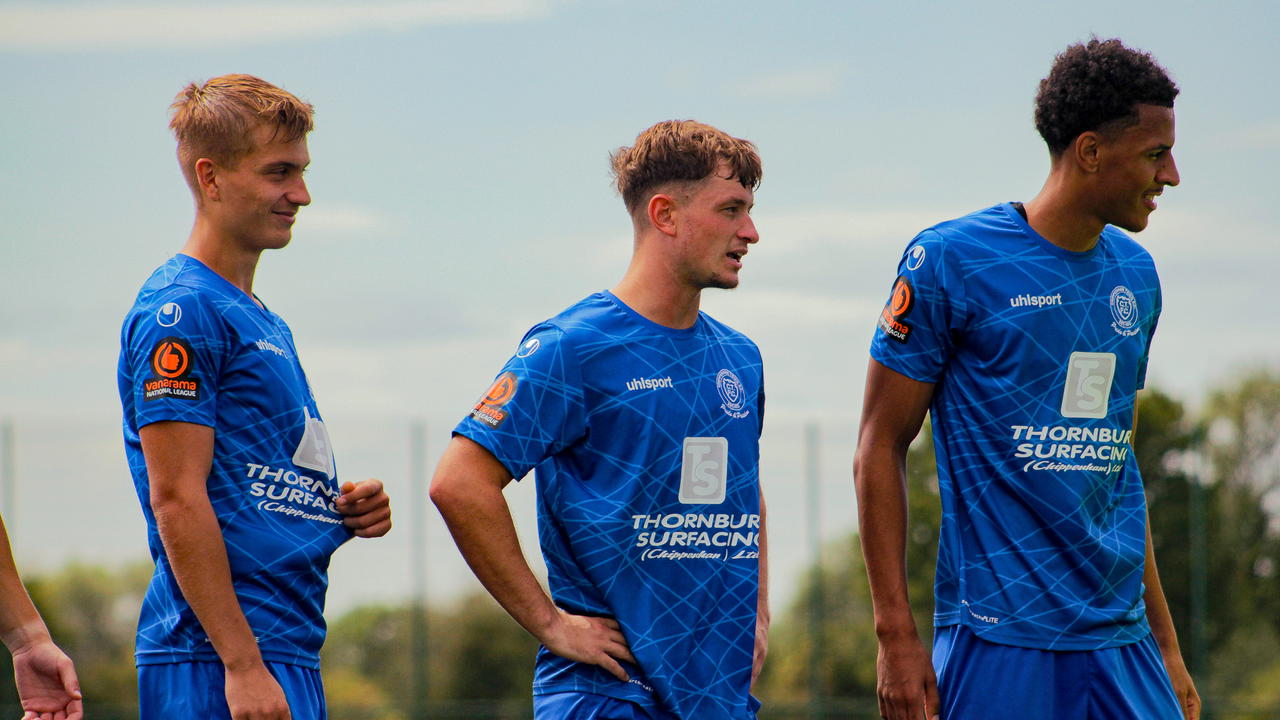 Chippenham Town men’s players in blue shirts